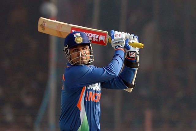 Indian cricketer Virender Sehwag plays a shot during his century innings on the first One-Day International (ODI) in Rajkot on December 15, 2009. Sri Lanka won the toss and elected to field, India are 217 runs at the loss of one wicket.  Sri Lanka lost the preceding Test series 2-0 and both teams won a Twenty20 match each.