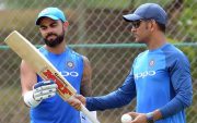 Virat Kohli and MS Dhoni. (Photo by LAKRUWAN WANNIARACHCHI/AFP/Getty Images)