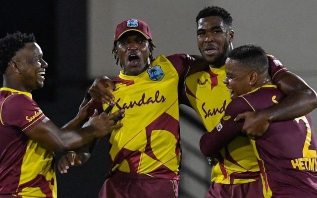 Obed McCoy and Dwayne Bravo of West Indies celebrate. (Photo by RANDY BROOKS/AFP via Getty Images)