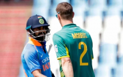 Virat Kohli and Chris Morris. (Photo by GIANLUIGI GUERCIA/AFP via Getty Images)