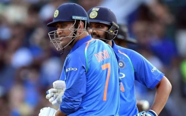 MS Dhoni and Rohit Sharma. (Photo by SAEED KHAN/AFP/Getty Images)