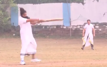 Men play cricket wearing dhoti-kurta